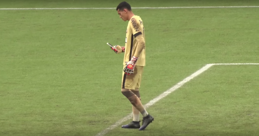 Goleiro Santos do Atlético Paranaense usando celular em campo. Foto: Reprodução/Youtube
